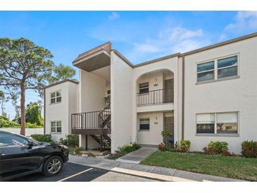 Charming condominium with a landscaped entrance, and a black car parked nearby at 7701 Starkey Rd # 504, Seminole, FL 33777