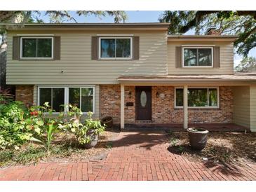 Charming two-story home featuring a brick facade, well-manicured landscaping, and a welcoming entryway at 8350 40Th N Ave, St Petersburg, FL 33709