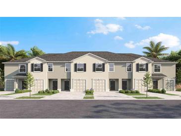 Charming townhome with a well-manicured lawn, dark shutters, and attached one car garage at 17261 Bigleaf Mahogany Ln, Land O Lakes, FL 34638