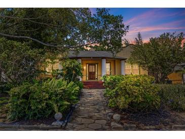 Charming home featuring lush landscaping and a welcoming entrance, under a colorful twilight sky at 202 39Th S Ave, St Petersburg, FL 33705