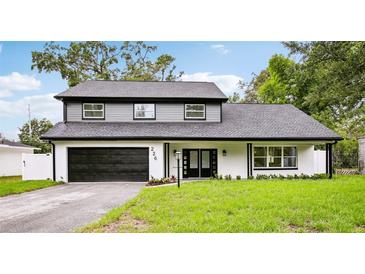 Beautiful two-story home featuring a well-manicured lawn and a two-car garage at 226 Willowick Ave, Temple Terrace, FL 33617