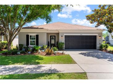Charming single-story home with well-manicured lawn, landscape beds, and a two-car garage at 2829 Maple Brook Loop, Lutz, FL 33558