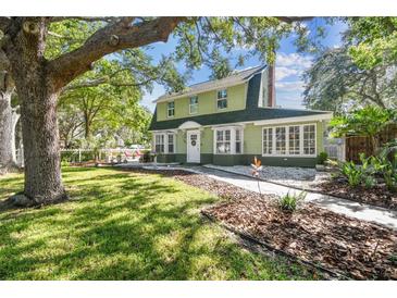 Charming two-story home featuring a lush front yard and inviting walkway to the front door at 301 81St Ne Ave, St Petersburg, FL 33702