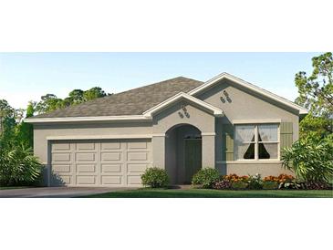 Charming single-Gathering home featuring a well-manicured lawn and a two-car garage at 35695 Lockman Way, Zephyrhills, FL 33541