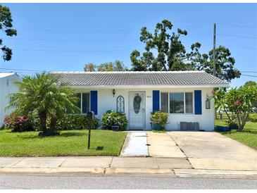 Charming single-story home featuring a well-maintained lawn and vibrant landscaping at 4211 93Rd N Ter, Pinellas Park, FL 33782
