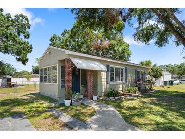 Charming single-story home with brick accents, inviting front entrance, and well-maintained landscaping at 1013 N Bask Dr, Tampa, FL 33603