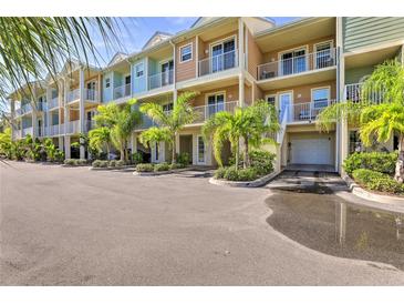 Charming townhouse complex featuring colorful facades, balconies, lush landscaping, and convenient parking at 3282 Mangrove Point Dr, Ruskin, FL 33570