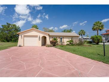 Charming single-story home featuring a spacious driveway and well-maintained landscaping under a sunny blue sky at 4315 Flexer Dr, Hernando Beach, FL 34607