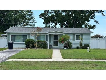Charming single-story home with well-manicured lawn, mature trees, and sidewalk to the front door at 5340 Denver Ne St, St Petersburg, FL 33703