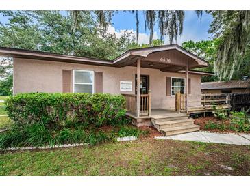 Charming single-story home with a inviting front porch and well-manicured lawn at 6406 Congress St, New Port Richey, FL 34653