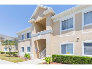 Well-maintained building featuring a beige exterior and white window trim at 9524 Newdale Way # 101, Riverview, FL 33578