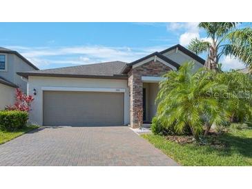 Charming one-story home featuring a two-car garage, stone accents, and well-maintained landscaping at 13213 Haystack Ct, Riverview, FL 33579