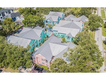 Colorful condo community boasts a pool, mature landscaping, and metal roofs at 3002 W Cleveland St # C3, Tampa, FL 33609