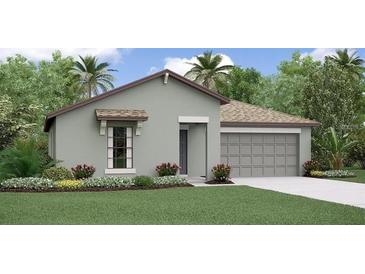 Inviting single-story home featuring a well-manicured lawn, complemented by an attached two-car garage and lush tropical landscaping at 4015 86Th E St, Palmetto, FL 34221