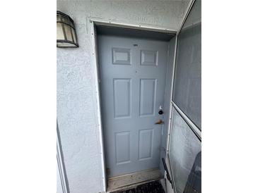 Close-up of a grey front door with unit number 412 and exterior light at 4148 Dolphin Dr # 3, Tampa, FL 33617