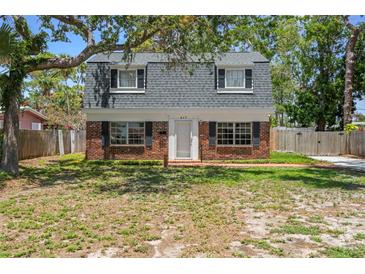 Charming brick home with black shutters and a well-lit, welcoming appearance with a neatly kept lawn at 417 66Th S Ave, St Petersburg, FL 33705