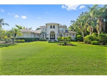 Beautiful two-story home featuring a well-manicured front yard and decorative shrubbery at 4512 Cheval Blvd, Lutz, FL 33558