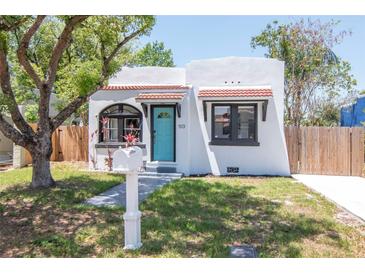 Charming bungalow with a tidy yard, brightly painted door, and eye-catching mailbox at 513 W Paris St, Tampa, FL 33604