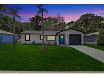 Charming single-story home featuring a well-manicured lawn and a freshly painted exterior at 6347 S Lansdale Cir, Tampa, FL 33616