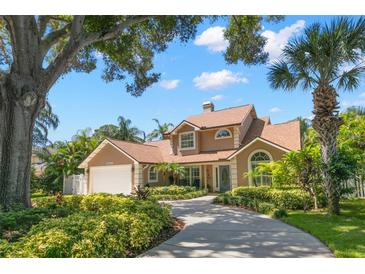 Charming single-Gathering home featuring manicured landscaping, a spacious driveway, and a two-car garage at 13598 Park Blvd, Seminole, FL 33776