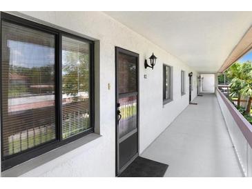 Inviting hallway featuring neutral colors, leading to residences with natural light, creating a serene and welcoming atmosphere at 172 Lakeview Way # 172, Oldsmar, FL 34677
