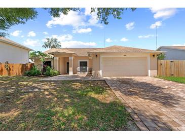 Charming single-story home with a two-car garage, paved driveway, and a well-maintained front yard at 10310 Salisbury St, Riverview, FL 33569