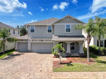 Charming two-story home featuring a three-car garage, paver driveway, and well-manicured landscaping at 10560 Lake Seminole Ter, Seminole, FL 33772