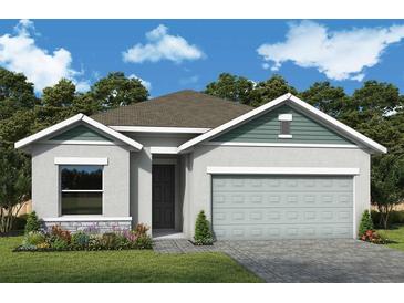 Charming single-story home featuring a two-car garage, beautiful landscaping, and a welcoming entrance at 10657 Crescent Creek Xing, Parrish, FL 34219