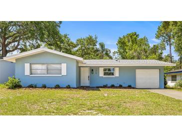 Charming single-story home featuring a well-manicured lawn and attached one-car garage at 1459 Joel Ln, Clearwater, FL 33755