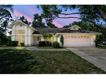 Charming single-story home featuring a two-car garage, manicured lawn, and beautiful twilight sky at 2901 50Th E Pl, Bradenton, FL 34203
