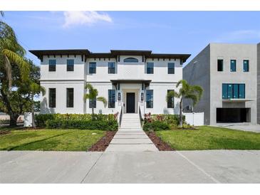 Stunning two-story home with black trim, elegant landscaping, and a welcoming entrance at 403 E Davis Blvd, Tampa, FL 33606