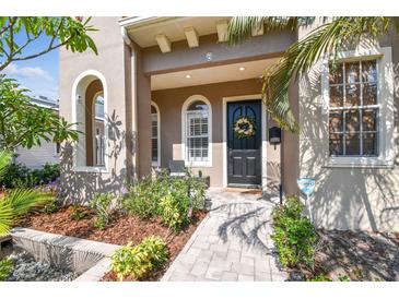 Charming home featuring a welcoming front porch, arched windows, and a beautifully landscaped walkway at 407 S Fremont Ave # B, Tampa, FL 33606