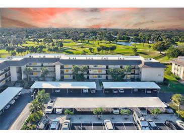 A condo building with covered parking and a golf course view at 12300 Vonn Rd # 7107, Largo, FL 33774