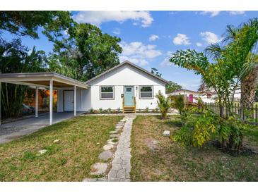 Charming single-story home with a well-manicured lawn and a covered carport at 1750 Dayton S St, St Petersburg, FL 33712