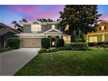 Charming two-story home featuring a well-manicured lawn, mature trees, and an attached two-car garage at 3530 Brook Crossing Dr, Brandon, FL 33511