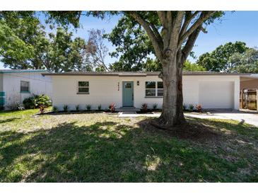 Charming single story home featuring a well-manicured lawn and painted brick facade at 5624 62Nd N St, St Petersburg, FL 33709