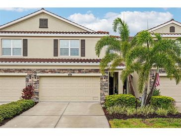 Charming townhome featuring a two-car garage and well-maintained landscaping at 601 52Nd Ter N, St Petersburg, FL 33703