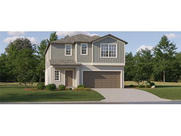 Charming two-story home featuring gray siding, a two-car garage, and a well-manicured lawn at 8778 Linked Dr, New Port Richey, FL 34655