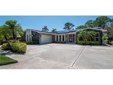 Charming single-story home featuring a circular driveway and a two-car garage at 1907 Sandpiper Dr, Clearwater, FL 33764