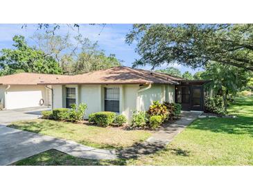 Charming single-story home features well-maintained landscaping and a welcoming entrance at 2150 Shelly Dr # D, Palm Harbor, FL 34684