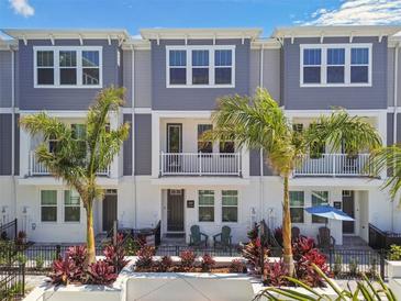 Charming townhome exterior with a balcony, well-kept landscaping, and a welcoming front porch at 448 31St N Ln, St Petersburg, FL 33713
