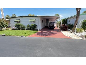 Charming single-story home with a covered parking area and well-maintained landscaping at 4851 W Gandy Blvd # 23C, Tampa, FL 33611