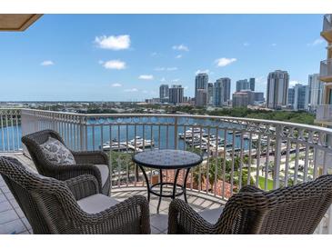 Enjoy breathtaking views from this condo's spacious balcony with comfortable seating overlooking the beautiful marina and city skyline at 555 5Th Ne Ave # 1032, St Petersburg, FL 33701