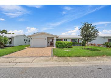 Charming single-story home with well-manicured lawn, brick driveway, and attached one car garage at 9226 41St N St, Pinellas Park, FL 33782