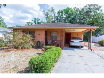 Charming single-story home with an attached covered carport and well-maintained front yard landscaping at 1512 W Sitka St, Tampa, FL 33604