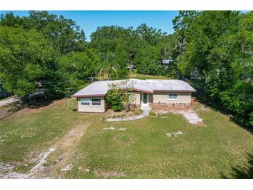 Charming single-story home with a rock detail, mature trees, and a well-maintained lawn at 2015 Pleasant Acre Dr, Plant City, FL 33566
