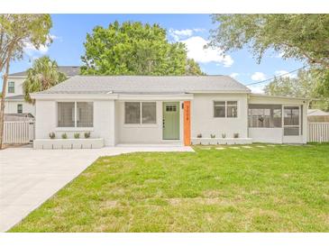 Charming single-story home with a well-maintained lawn and freshly painted white brick exterior at 3008 W Van Buren Dr, Tampa, FL 33611