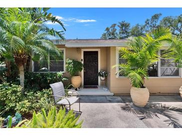 Charming home featuring a beautiful, intricately designed front door surrounded by lush landscaping at 3626 S Hesperides St, Tampa, FL 33629