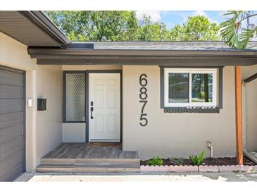 Charming home featuring a well-lit front door and stylish house numbers at 6875 11Th N Ave, St Petersburg, FL 33710