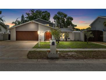 Charming single-Gathering home with a well-manicured lawn and beautiful landscaping at 8203 Kirkwood Dr, Tampa, FL 33634